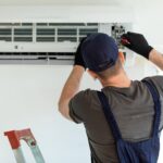 Man repairing the internal unit of a split system air conditioner.