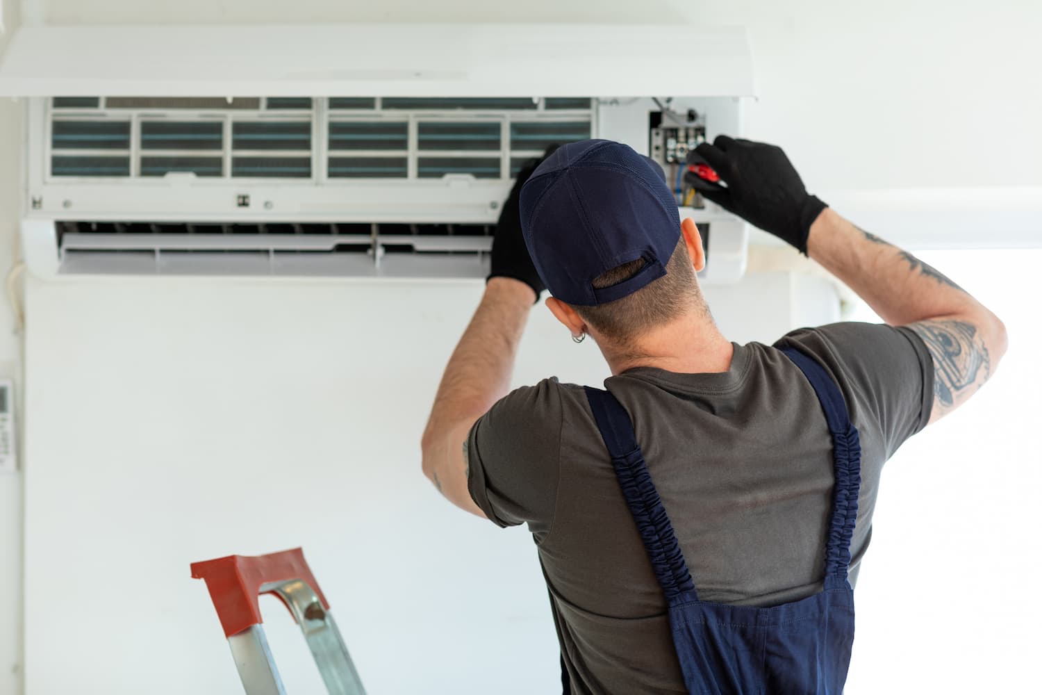 Man repairing the internal unit of a split system air conditioner.